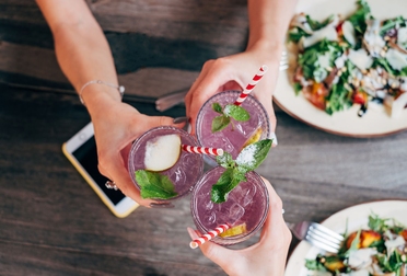 Friends toasting at dinner table